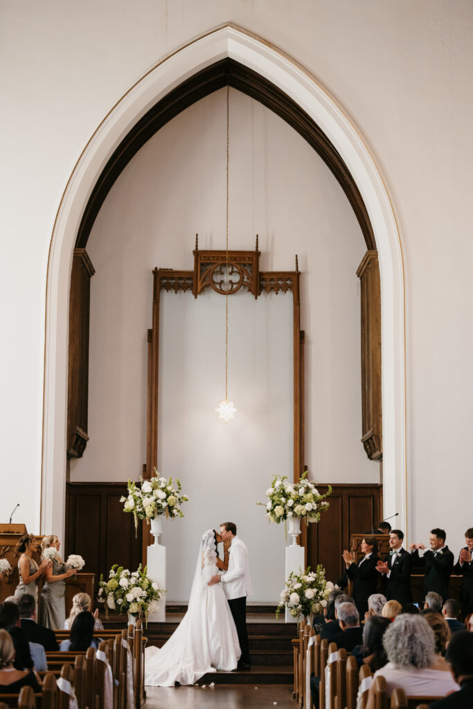 bride and groom first kiss
